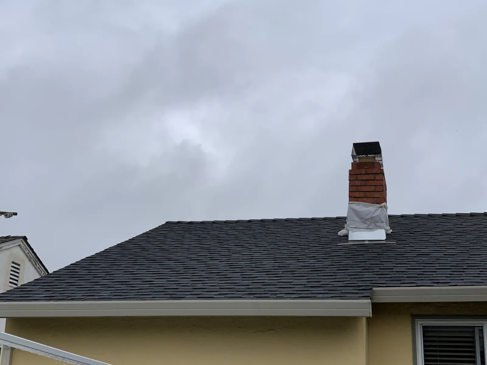 New architectural composition shingle roof with chimney flashing in San Mateo