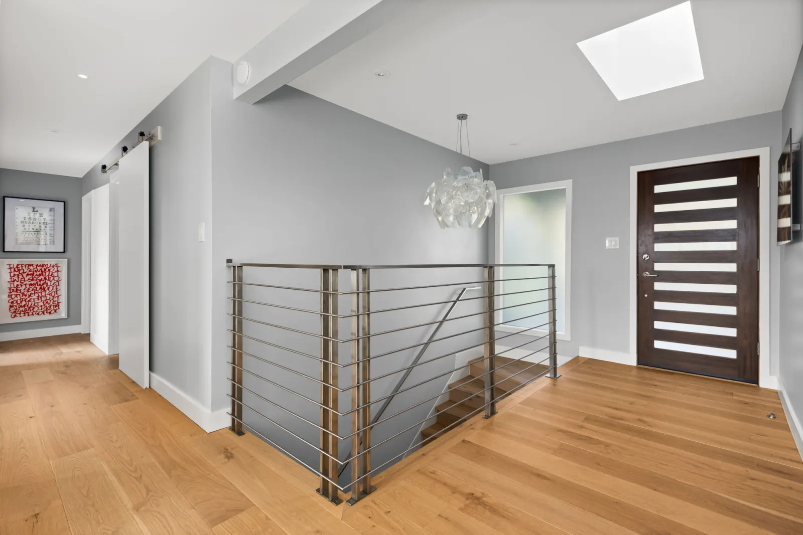 Whole-home remodel with wide-plank hardwood floors and modern cable-rail staircase in Mill Valley